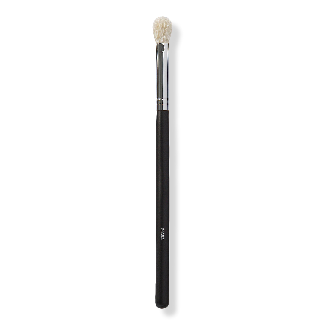 A black, silver, and white eyeshadow brush