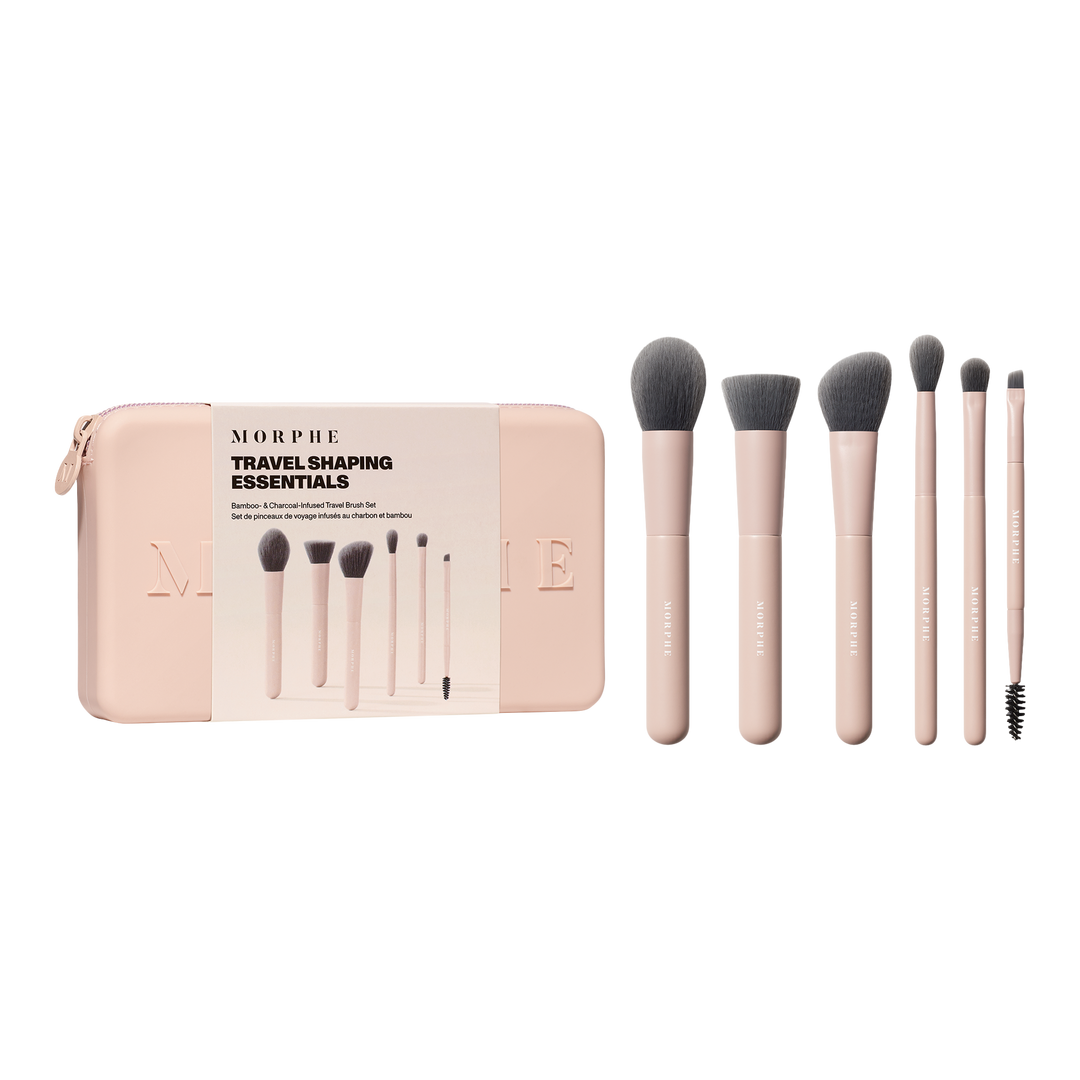 6 pink and grey makeup brushes next to a pink travel case